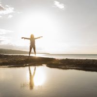 woman-posing-beach-with-sun-square